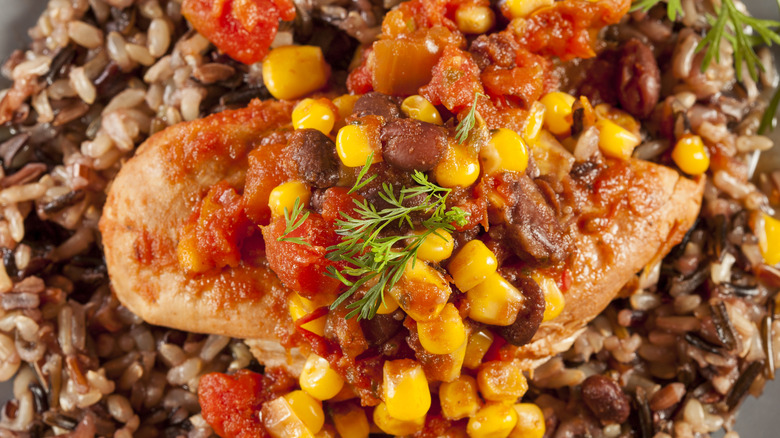 Southwest chicken on rice topped with beans, salsa, and corn
