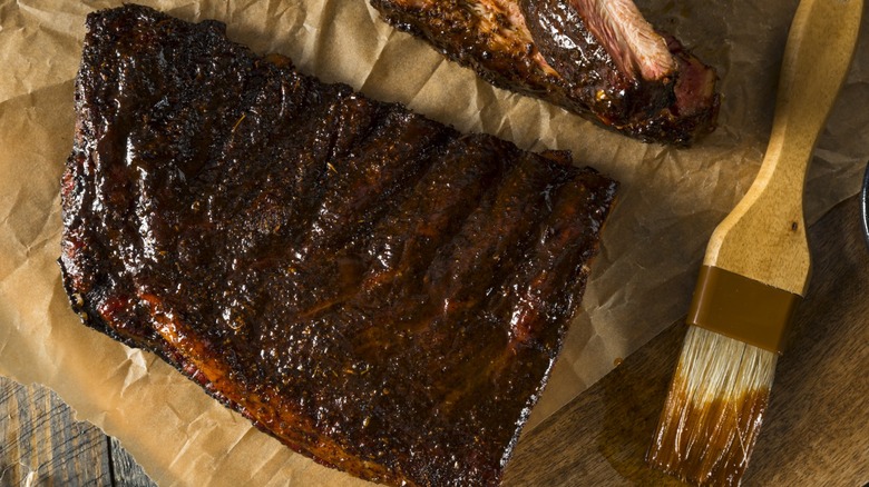 A half-slab of baby back ribs on a piece of parchment paper.