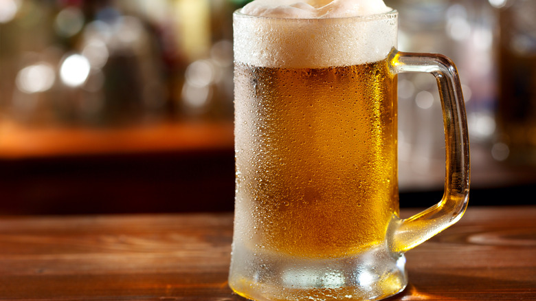 An ice cold mug full of freshly-poured beer.