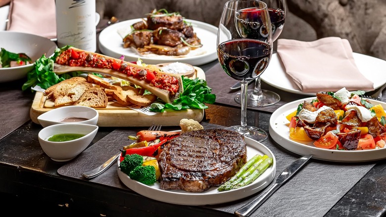 Wine and meals on table at a steakhouse