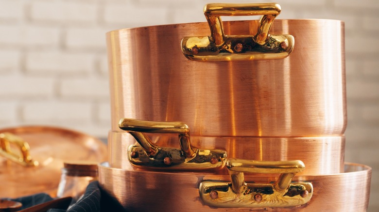 Stack of copper pots and pans.