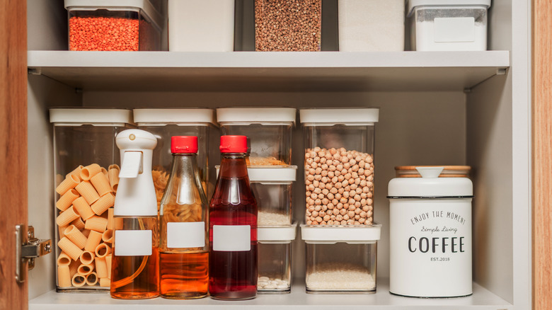 A kitchen pantry filled with containers of food