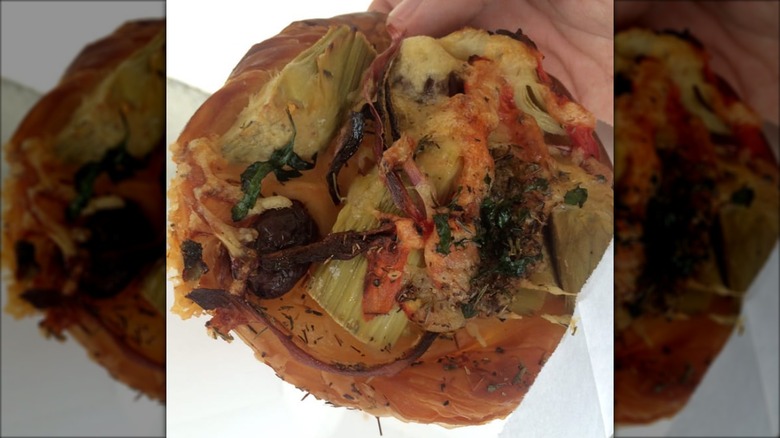 Hand holding artichoke rose from Uppercrust