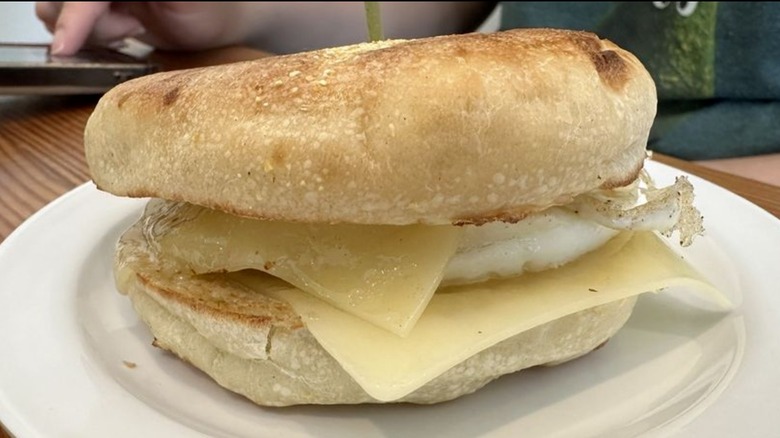 Vinal Bakery's English Muffin Breakfast sandwich with egg and cheese on white plate