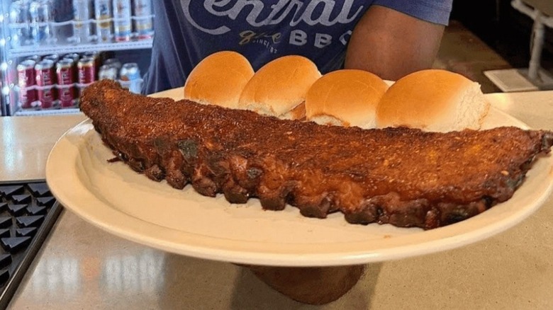 Central BBQ ribs on a plate with bread rolls