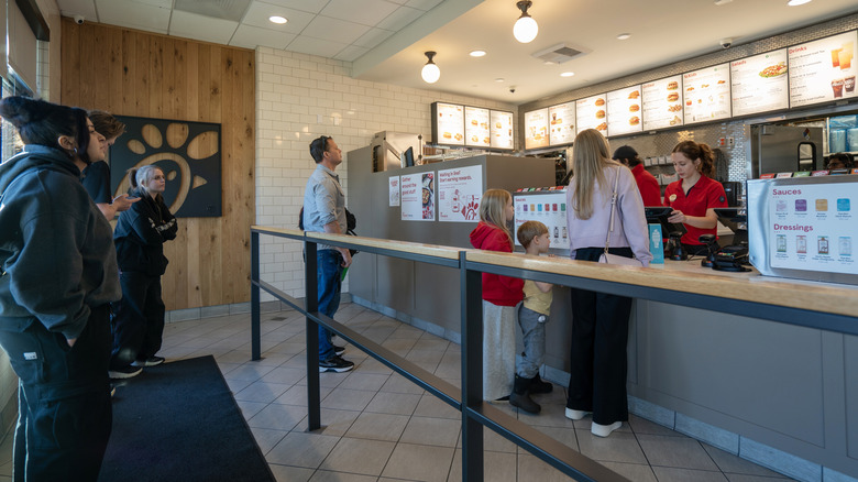 Customers in line at Chick-fil-A waiting to order.