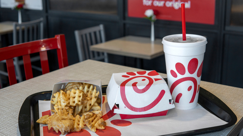 Chick-fil-A waffle fries, a sandwich and a soda