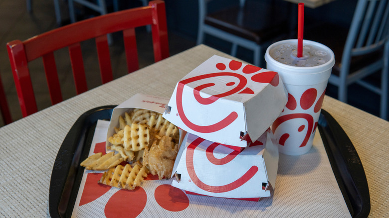 Two sandwiches, fries, and a drink from Chick-fil-A sitting on a tray.