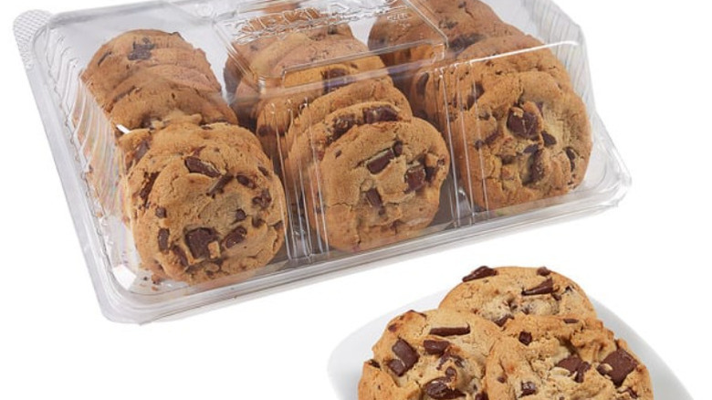 Three Kirkland Signature Gourmet Chocolate Chunk Cookies on a plate in front of a container