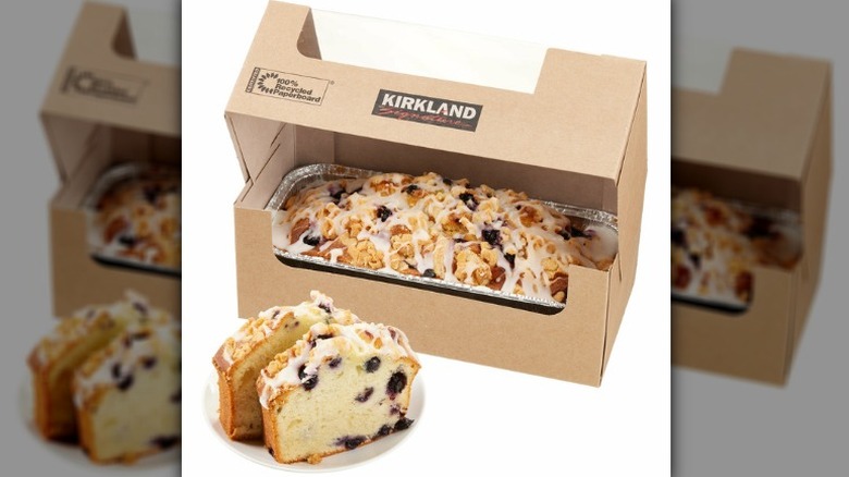 Two slices of Kirkland Signature Lemon Blueberry Loaf on plate in front of a full loaf