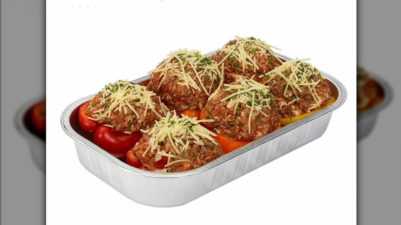 The stuffed bell peppers from Costco's deli section with ground meat topped with shredded cheese in aluminum tray
