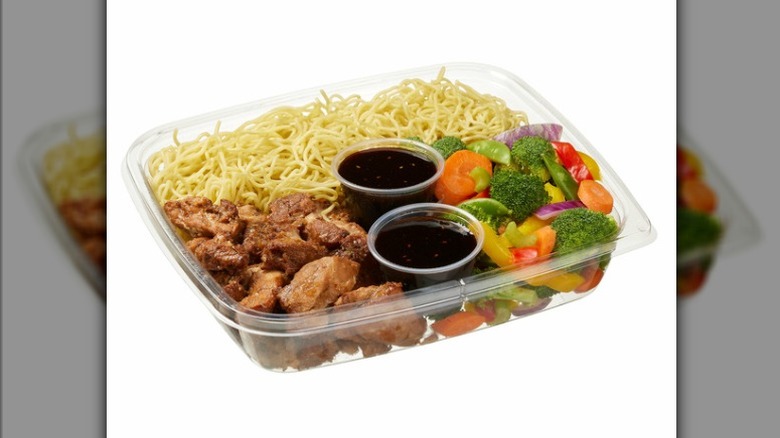 The Kirkland Signature Yakisoba Stir Fry kit from Costco, including seasoned chicken, two containers of yakisoba sauce, veggies, and noodles