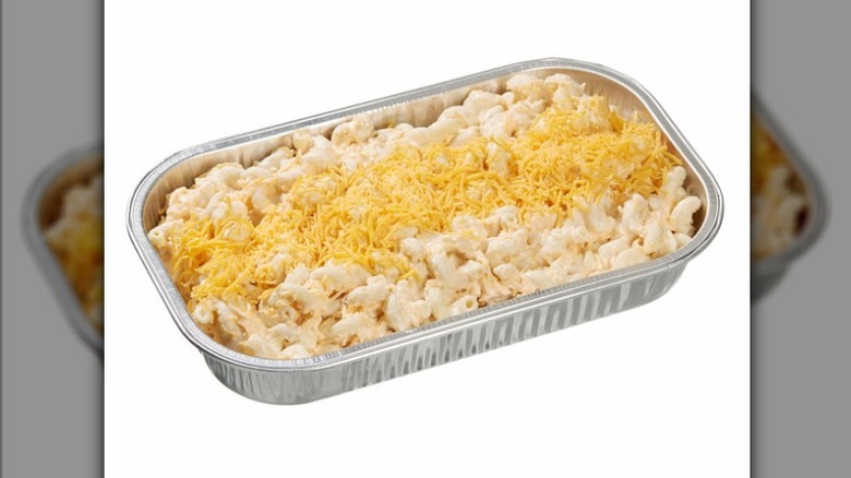 The Kirkland Signature Mac and Cheese from Costco in aluminum foil tray topped with shredded cheese