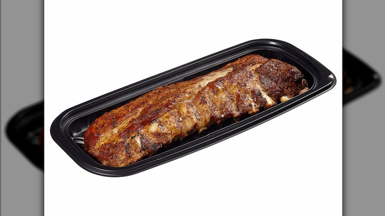 Cooked, seasoned St Louis style ribs from Kirkland Signature in plastic tray