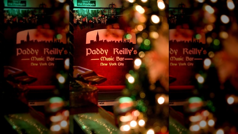 Paddy Reilly's Music Bar sign surrounded by lights inside the bar in New York City
