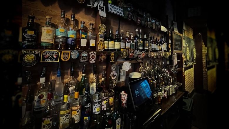 Shelves of liquor behind bar at The Belfast Mill in Charlotte