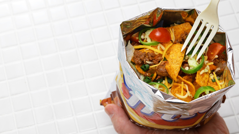 A walking taco in a bag of Chili Cheese Fritos.