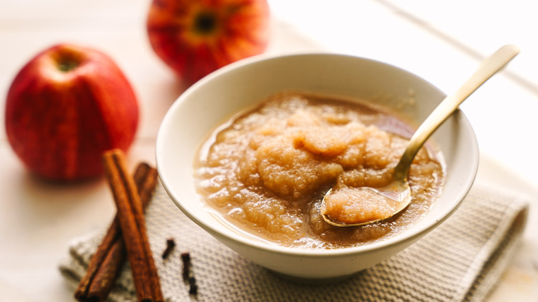 Puréed apples in a white bowl with cinnamon