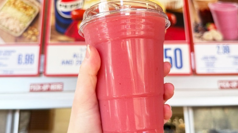 hand holding strawberry-banana smoothie at Costco  food court