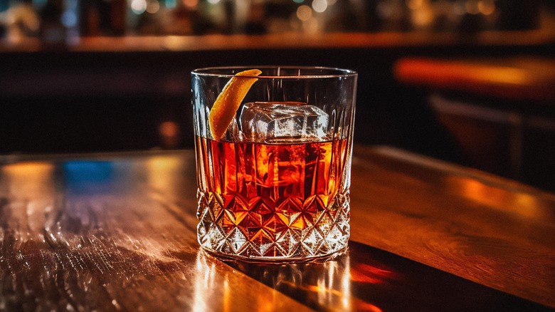 Old Fashioned cocktail in a rocks glass on a wooden table