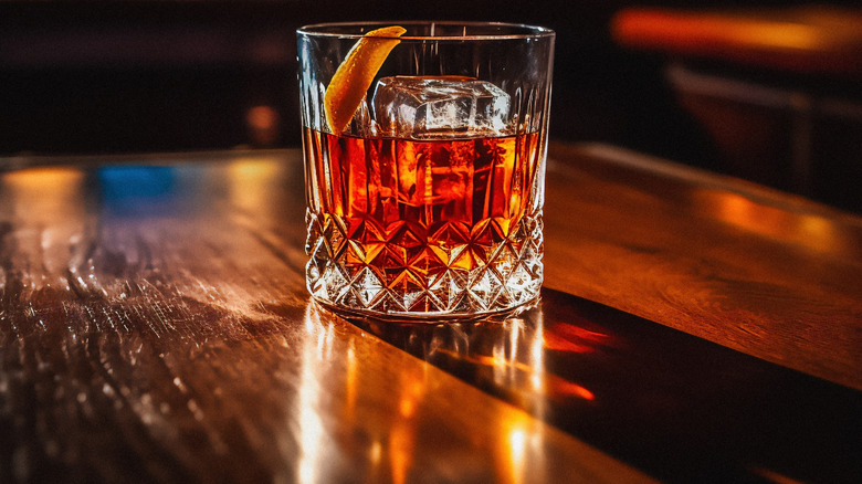 Old Fashioned cocktail in a rocks glass on a wooden table