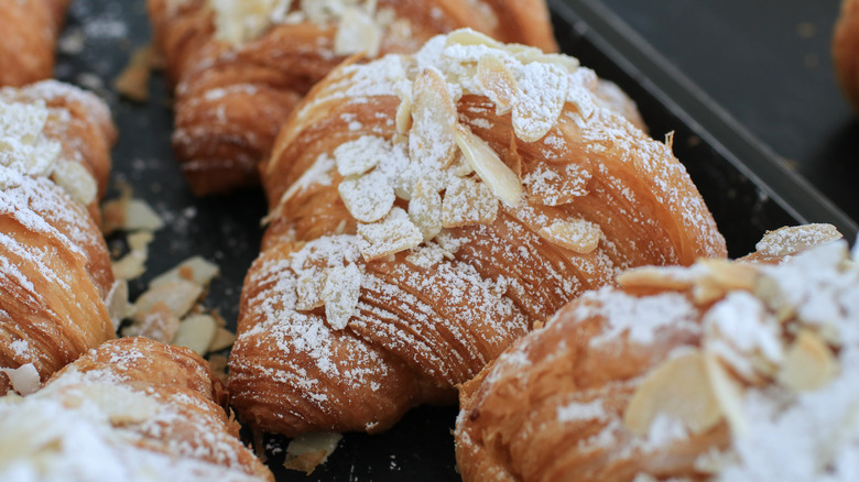 almond croissants with powdered sugar and sliced almonds