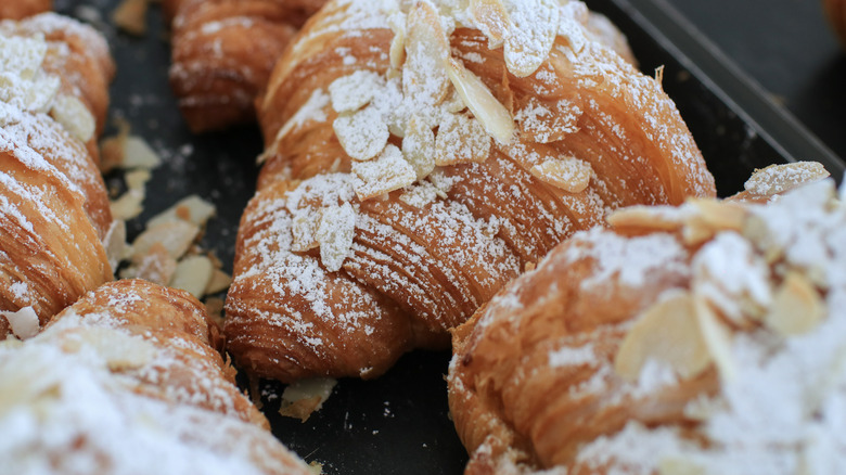 almond croissants with powdered sugar and sliced almonds