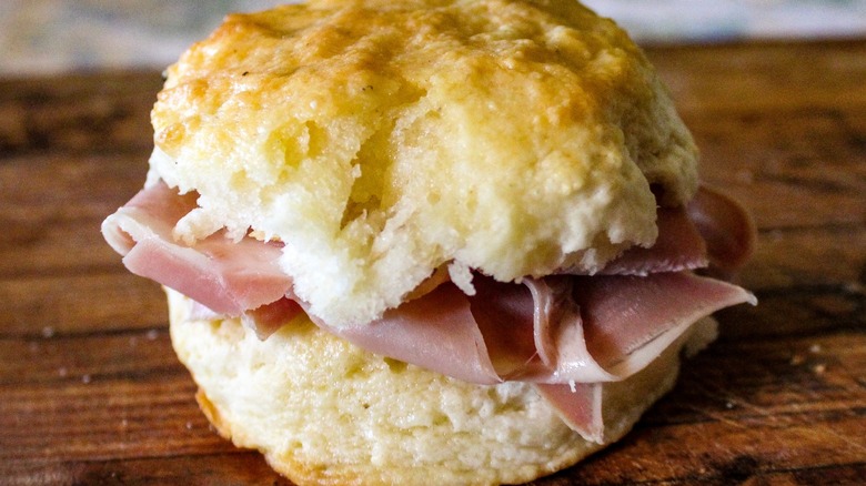 Close up of Country Ham Biscuit on wooden surface