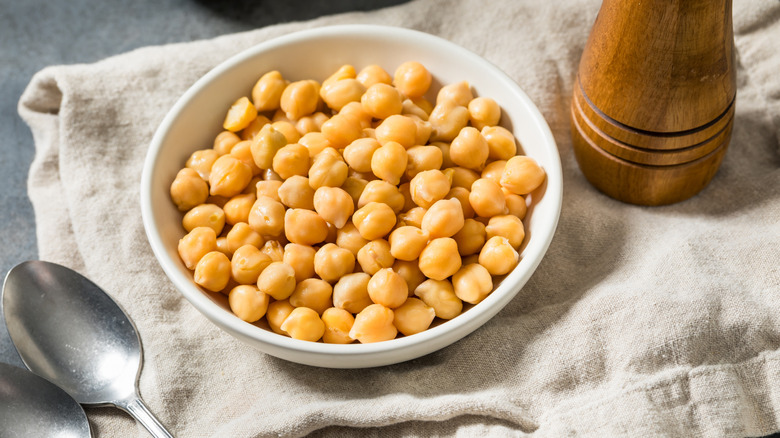 White bowl filled with canned chickpeas on a cloth napkin