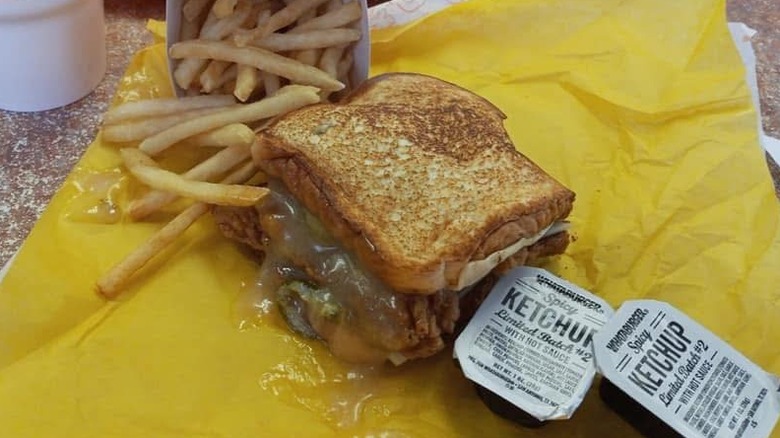 A honey BBQ sandwich, with the honey BQQ sauce swapped for honey butter with two packages of ketchup and a side of fries on the wrapper