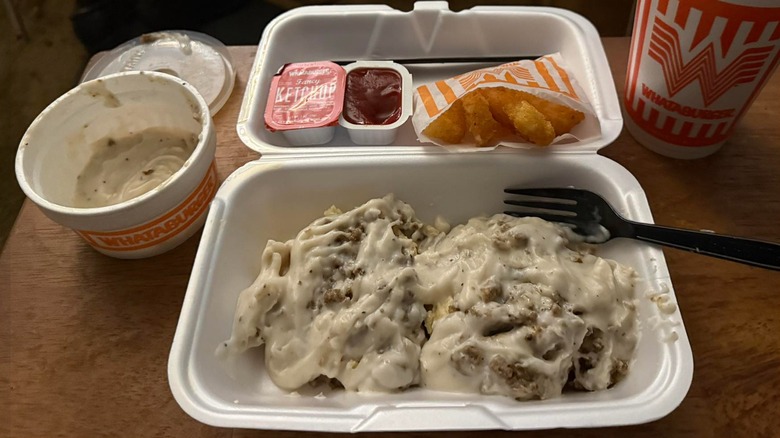 Whataburger biscuits and gravy with hash brown Krispers and sweet tea in a to-go container
