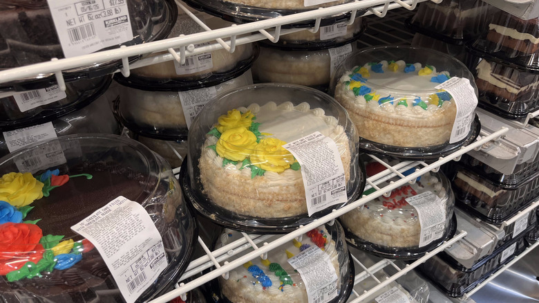 rows of colorfully decorated round Costco cakes for various occasions on a shelf