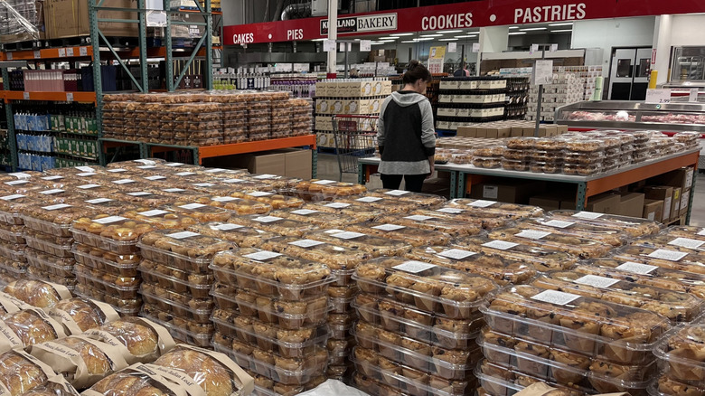 inside of a Costco bakery with shoppers surrounded by various baked goods