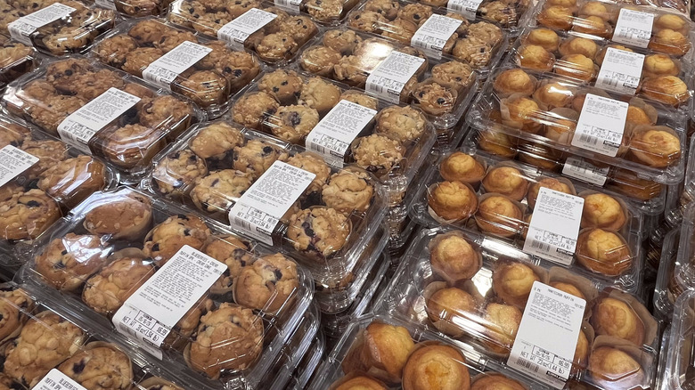 stacked clamshells of Costco muffins on a shelf