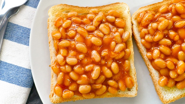 Beans on toast with fork and knife on a plate