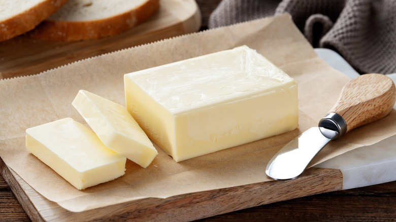 Sliced butter on cutting board