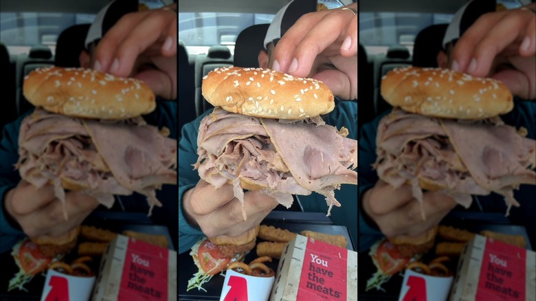 Person holding an Arby's classic roast beef sandwich
