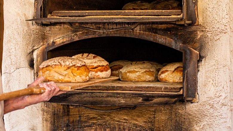 Baking bread in an old time stone wood fired oven