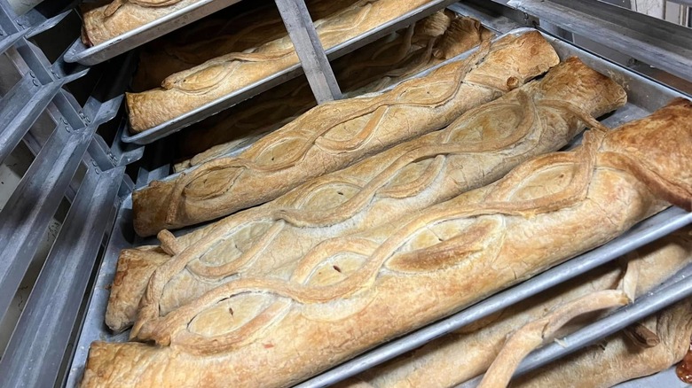 Massive apple strudels on baking trays cooling on baking racks at Naegelin's Bakery in New Braunfels, Texas