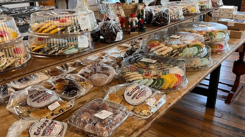 Full baked goods display with packaged breads and trays of cookies at Trefzger's Bakery in Peoria Heights, Illinois