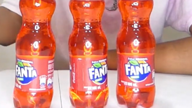 three plastic bottles of Fanta Kolita Soda