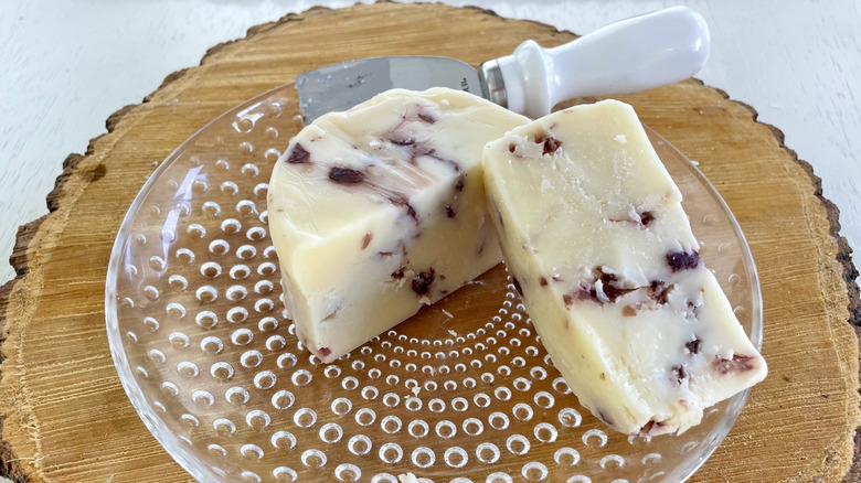 A round of cranberry white cheddar cut in half