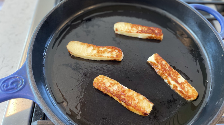 Slices of Aldi bread cheese in a frying pan