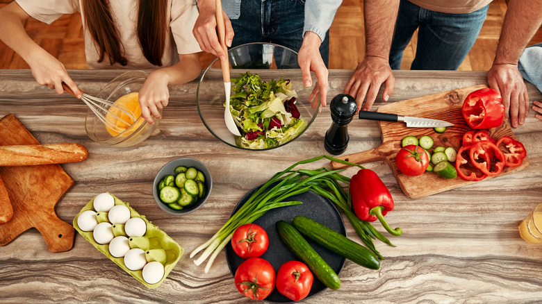 several people cooking in a kitchen