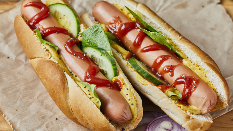 hot dogs with ketchup, mustard, and cucumbers