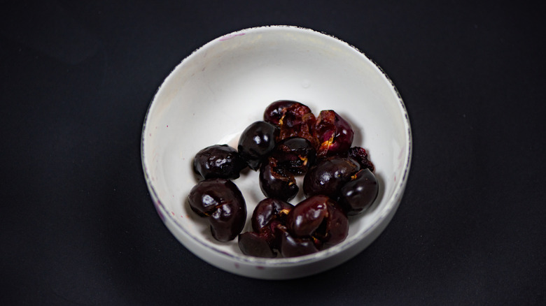 pitted cherries in a white bowl