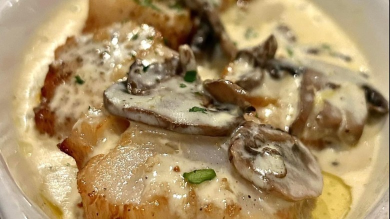 Scallops with a mushroom cream sauce from Bruno's Little Italy on a white plate
