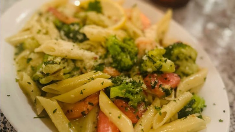 Pasta with fresh veggies at Mama Carolla's on a white plate