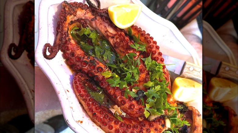 Octopus entrée with slice lemon as garnish at Ortobello's on a large white platter