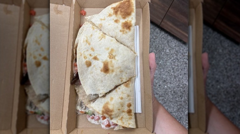 Wawa chicken bacon ranch quesadilla in a brown to-go container
